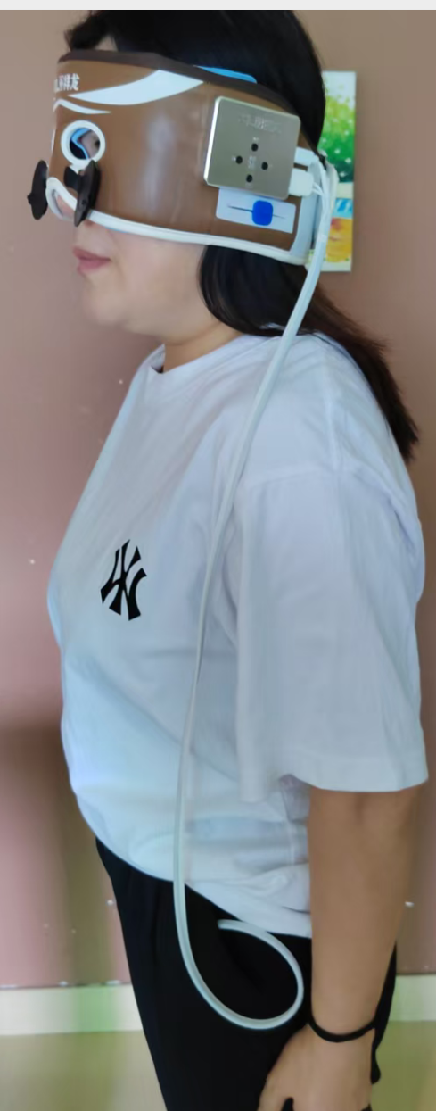 Full side view of Xianglong smart eye and head massager worn by a user