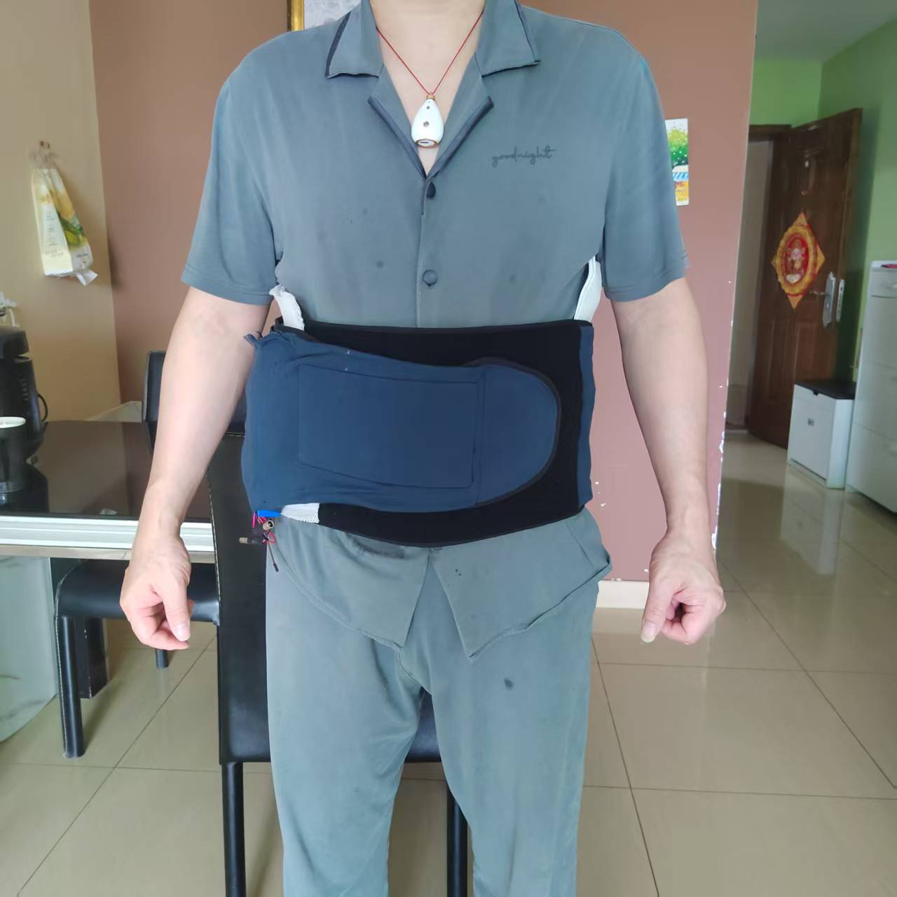 NICNOL nitinol heating massage belt worn while bending, showing flexibility